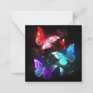 Three Glowing Butterflies on night background Card