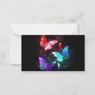 Three Glowing Butterflies on night background Card