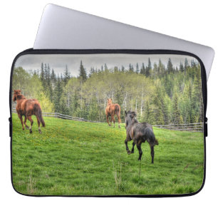 Three Horses Running on Fresh Grass in a Paddock Laptop Sleeve