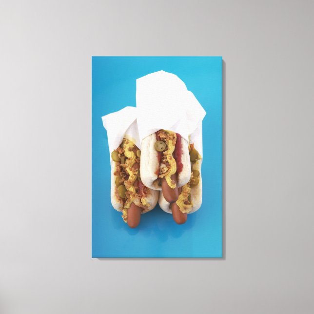 Three hot dogs in buns canvas print (Front)
