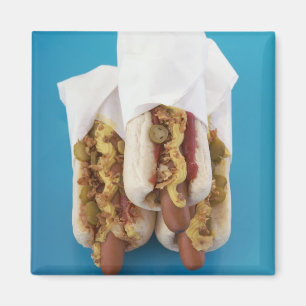Three hot dogs in buns magnet
