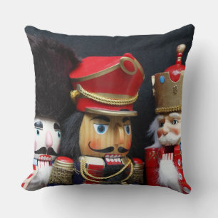 Three nutcrackers on black throw pillow