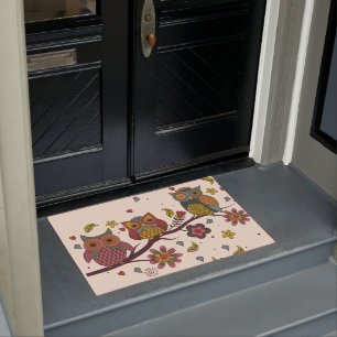 Three owls on branch doormat