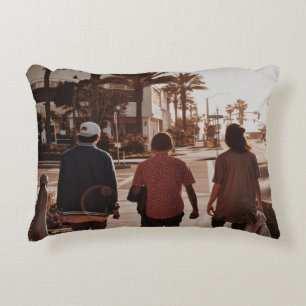 Three persons walking near palm trees accent pillow