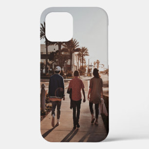 Three persons walking near palm trees iPhone 12 case