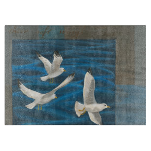 Three White Seagulls Flying Over the Water Cutting Board