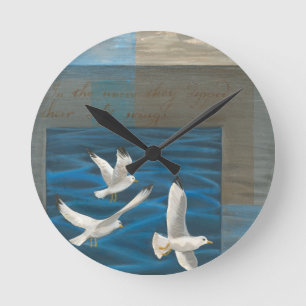 Three White Seagulls Flying Over the Water Round Clock