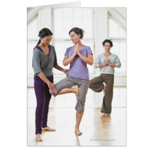 Three women practicing yoga
