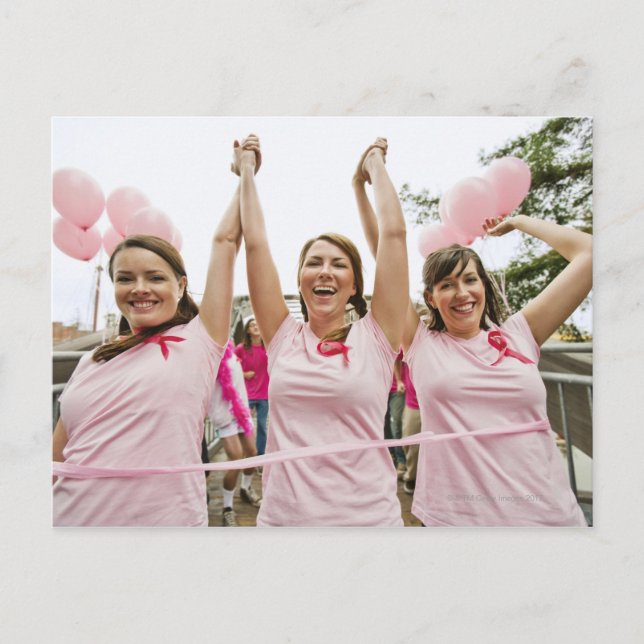 Three young women dressed in pink run in postcard (Front)