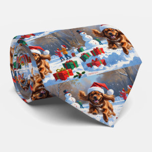 Tibetan Spaniel Running in Snow with Christmas Hat Tie