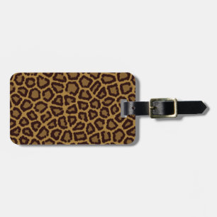 Tile background with a leopard fur luggage tag