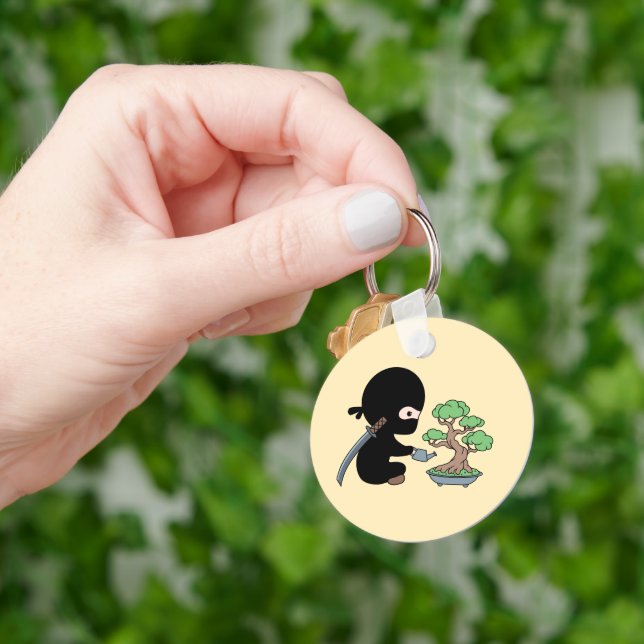 Tiny Ninja Watering Bonsai Tree on Yellow Keychain (Hand)