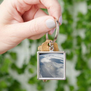Tiny Satellites Orbit Above A Part Of Earth. Keychain