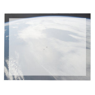 Tiny Satellites Orbit Above A Part Of Earth. Notepad