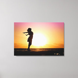 Toile Bonheur de femme au coucher de soleil sur la plage