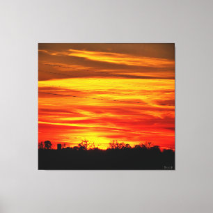 Toile Coucher de soleil vibrant sur les arbres