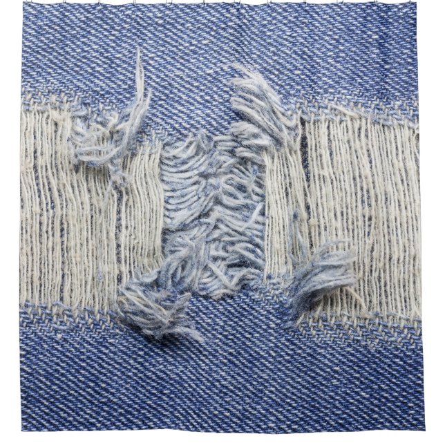 Torn blue denim: jeans texture. (Front)