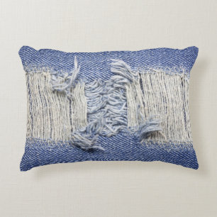 Torn blue denim: jeans texture. accent pillow