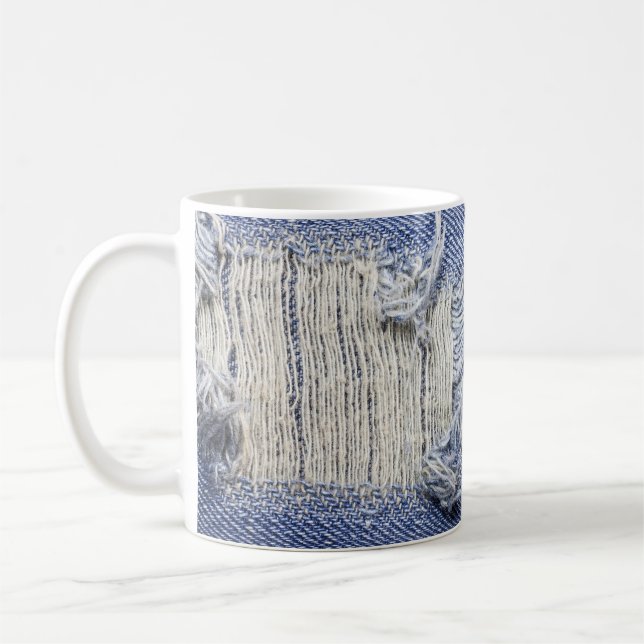 Torn blue denim: jeans texture. coffee mug (Left)