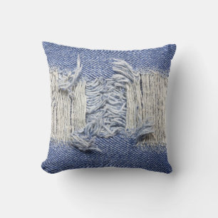 Torn blue denim: jeans texture. throw pillow
