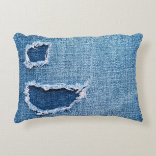 Torn denim fabric texture, blue hues. accent pillow