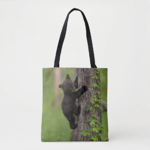 Tote Bag Jeune ourson noir grimpant à un arbre
