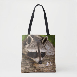 Tote Bag Raccoon mignon reposant sur un journal