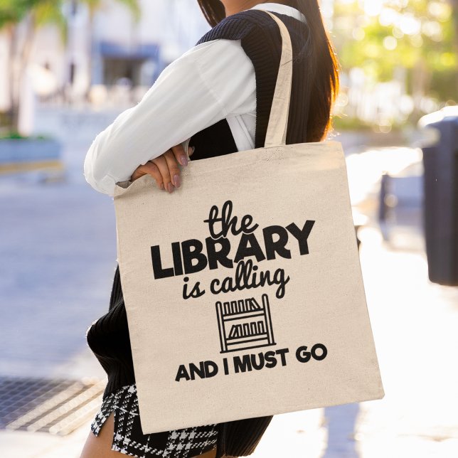 Tote Bag The Library Is Calling And I Must Go Reading Books (This tote bag is perfect for book lovers who can’t resist the call of the library.)