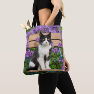 Tote Bag Tuxedo cat sitting on a garchair with flowers