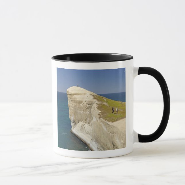 Tourists on cliff top at Tunnel Beach Mug (Right)