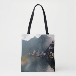 TOWN BESIDE BODY OF WATER AND MOUNTAINS TOTE BAG
