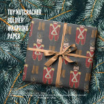 Toy Nutcracker Soldier Wrapping Paper<br><div class="desc">Festive Nutcracker-Themed Gift Wrap for Elegant Holiday Gifting Description: Add a touch of timeless charm to your holiday presents with this Nutcracker-themed gift wrap. Featuring classic soldiers in bold red uniforms with gold accents, the design pops against a sophisticated dark background, perfectly tied with a soft ribbon. Ideal for Christmas...</div>