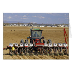 Tractor pulling a seed corn planter.