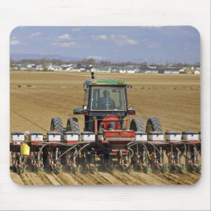 Tractor pulling a seed corn planter. mouse pad