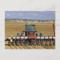 Tractor pulling a seed corn planter.