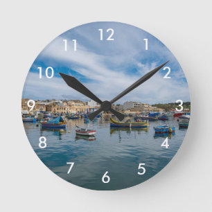 Traditional colorful fishing boats in the harbor round clock