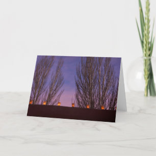 Traditional farolitos light up adobe structures card
