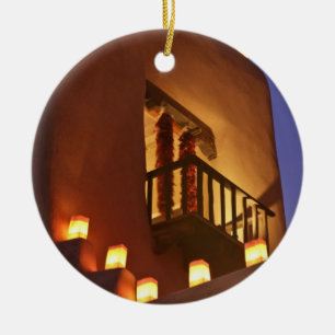 Traditional farolitos light up adobe structures ceramic ornament