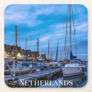 Traditional fishing town night scene. square paper coaster