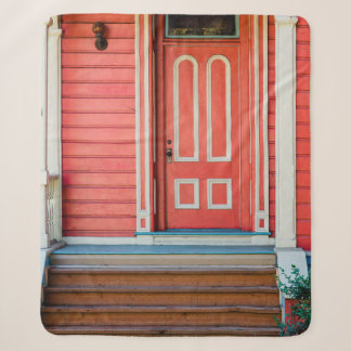 Traditional red painted wooden door and porchdoor, sherpa blanket