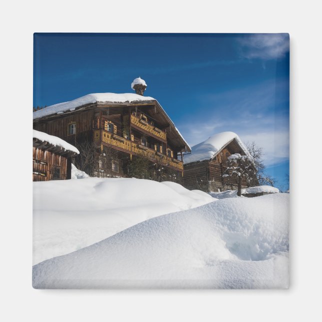 Traditional wooden cabins in de snow magnet (Front)