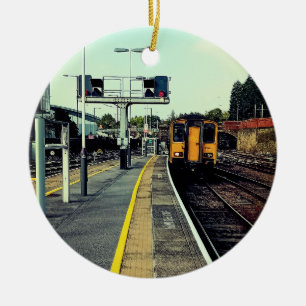 Train on the tracks ceramic ornament