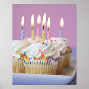 Tray of birthday cupcakes with candles poster