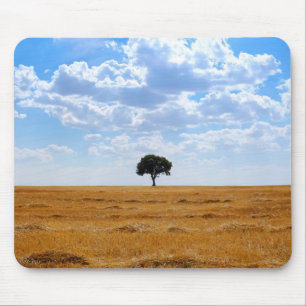 Tree in an harvested wheat field mouse pad