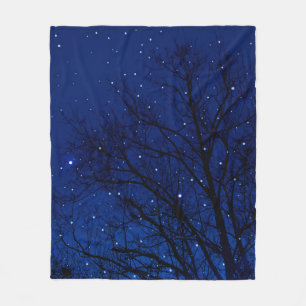Trees against starry sky background. Trees at nigh Fleece Blanket