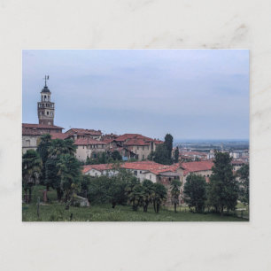 Trees and buildings in city against sky postcard