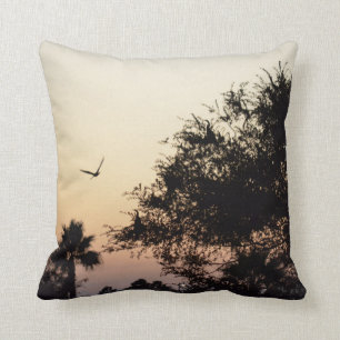 trees and flying bird against florida sunset throw pillow
