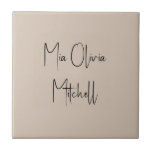 Trend Colour Soft Taupe Name Ceramic Tile<br><div class="desc">Introducing the classic spring shade: Soft Taupe. Elevate your home decor with our modern and stylish ceramic tile, featuring a customizable name in a charming handwritten font in classic black, looking like a signature. Its elegant and minimalist design in solid colours exudes timeless appeal, making it perfect for personal use...</div>