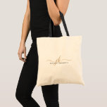 Trendy Black Gold Monogram Script Initials Name Tote Bag<br><div class="desc">Modern, minimalist personalized tote bag featuring a trendy handwritten script monogram or initials and name in editable black and gold colours for a stylish or elegant professional look. ASSISTANCE: For help with design modification or personalization, colour change, resizing, transferring the design to another product or if you would like coordinating...</div>