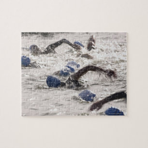 Triathletes competing in swim leg of triathlon. jigsaw puzzle